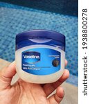 Small photo of Indonesia, 17 March 2021: Selective focus, Jar of Vaseline Original Petroleum Jelly with pool background.