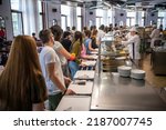Small photo of Students being served meal in school canteen. Lunch break. Education people and student in line wait for food meals and eating food in cafeteria. Belgrade, Serbia 17.05.2022