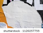 Small photo of Layers of ripped off wall posters, torn street billboard paper