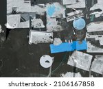 Small photo of Layers of ripped off street wall stickers, torn creative ghetto flyer background 