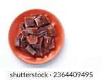 Small photo of Jerked beef in an orange color plate, white background. In Brazil it is know as “Carne seca”, “Carne de Sol” or “charque”. Dried meat sliced raw. Traditional brazilian food.
