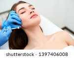 Small photo of Beautician doctor with filler syringe making injection to jowls. Masseter lines reduction and face contouring therapy. Anti-aging treatment and face lift in cosmetology clinic. Patient lying on chair