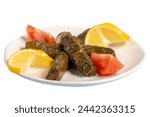 Small photo of Stuffed grape leaves with olive oil. Appetizer dishes. Stuffed stuffed leaves with meat isolated on white background. local name yaprak sarma. Close up