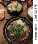 Small photo of New York, USA - 23rd December, 2023: Ootoya has the best Washu Beef Sukiyaki and Salmon Tonyu Nabe Pot in New York City.