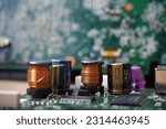 Small photo of Close up of electronic components on circuit board. Focused on coil and capacitor.
