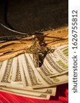 Small photo of Money in book, church tethe concept. Close up, old vintage holy bible, us dollars and golden cross.