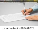 Small photo of Woman's hands signing office papers. Close-up of secretary's daytime paperwork. One siganture makes many changes. Think before you sign.