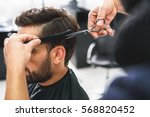 Barber using scissors and comb