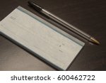 Small photo of Document for transferring funds/Bank Check and Pen/Writing instrument with promissory note.