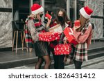 Three portrait of young happy women in red Christmas clothes, medical masks, hats and gifts walking in the city and shopping in quarantine.  