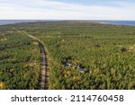 Finland, Hailuoto September 26, 2021. Road in the forest, view from the top to the coastline. Landscape from a drone on an autumn sunny day. Nature and landscape of Scandinavia