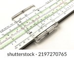 Small photo of Vintage slide rule. A calculating and measuring instrument. Isolated on white background.