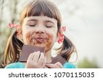 A sweet-toothed child eats chocolate. Selective focus. 