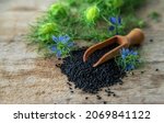 Small photo of Black cumin seeds and flowers. Selective focus. Nature.