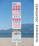 Small photo of Vancouver, BC Canada - August 11, 2021. Bylaw and Lifeguard signage at Jericho Beach in Vancouver.