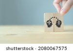 Small photo of Knowledge and ideas sharing between two people head icon on wooden cube. Transferring knowledge, innovation, brainstorming concept. Business strategies to technology evolution re-skill and new skill.
