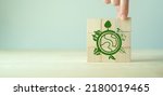 Small photo of Eco friendly, green company culture concept. Carbon neutral and net zero target. Sustainable enviroment and business limit global warming. Build green community. Wooden cubes with eco globe icon.