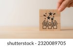 Small photo of Customer advocacy and loyalty concept. Loyal customers sharing their experiences with your business and help other customers get the most value out. Wooden cube blocks with advocacy and loyalty icon.
