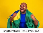 handsome afro brazilian man wearing glasses, brazilian fan, brazil, world cup 2022, clenched fists, screaming, cheering, vibrating, goal.