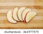 Sliced apple isolated on wooden board