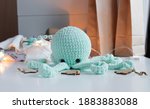 blue knitted octopus toy sits... | Shutterstock . vector #1883883088