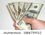 u.s. dollars in hand on a white ... | Shutterstock . vector #1886759512