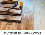 The process of house renovation with changing of the floor from carpets to solid oak wood. Beautiful golden handscraped oiled European oak brushed for added texture and fine definition of wood grain
