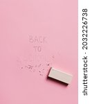 Small photo of Back to school erased note on a pastel pink background. Creative school concept. Flat lay, top view.