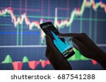 Businessman checking stock market data. He using a mobile phone. Analysis economy data on forex earn graph. 