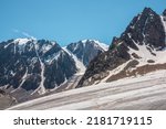 Small photo of Scenic mountain landscape with glacier under sharp rocks in sunlight. Awesome landscape with glacial tongue and rocky pinnacle in sunshine. Beautiful view to snow mountains at very high altitude.