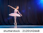 A little girl ballerina is...