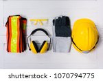Standard construction safety equipment on white wooden background. top view, safety first concepts