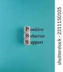 Small photo of Positive behavior support symbol. Concept black words Positive behavior support on wooden cubes on a beautiful blue background. Business, psychological and Positive behavior support concept.