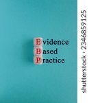 Small photo of Text EBP Evidence-based practice concept on wooden cubes. Beautiful blue background. Business concept.