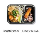Top View of Shrimp Pad Thai with Fried Spring Roll and Sweet Sauce in Takeaway Box on White Background. Asian Food. Delivery Food. Clipping Path on the main object (not the shadow) Included.