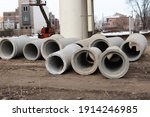 Small photo of concrete drainage pipe construction stacked at roadsides for industrial building ditty