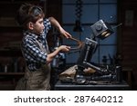 Young boy mechanic repairing...