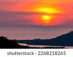 Big yellow sun setting down over sea surface in sunset or sunrise sky,Amazing nature landscape view 
