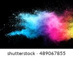 Freeze motion of blue and pink color powder exploding on black background.