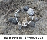 Pebbles In A Circle On A Beach...