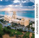 Small photo of Ras Al Khaimah, United Arab Emirates - December 4, 2021: Waldorf Astoria hotel and resort in Ras al Khaimah near Al Hamra village aerial view at sunset