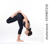Small photo of Beautiful sporty woman doing advanced yoga practice on white background. Unsupported bound one foot intense stretch pose.