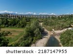 Small photo of Cuneo, Piedmont, Italy: The Soleri viaduct, it is a promiscuous road and rail bridge on the Stura di Demonte river, in the background the mountains of the Alps