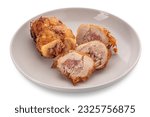 Small photo of Chicken roulade. Slices of rolled roast chicken meat stuffed with bacon in white dish isolated on white with clipping path