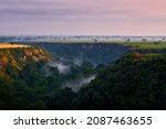 Small photo of Kyambura Gorge, magnificent valley of apes in the Queen Elizabeth National Park in Uganda. Africa morning landscape with forest. Savannah with gorge and tress. Uganda nature sunrise.