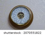 Small photo of barometer with the inscription in Russian storm wind clear dry