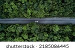 Small photo of Aerial view green forest and asphalt road, Top view forest road going through forest with car adventure, Ecosystem ecology healthy environment road trip travel.