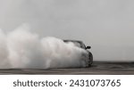 Small photo of Blurred car drifting diffusion race drift car with lots of smoke from burning tires on speed track, Professional driver drifting car with lots of white smoke .