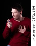 Small photo of Young man using nitroglycerin to relieve chest discomfort