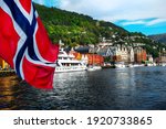 Norwegian flag with the port of Bergen and view on the historical buildings of Bryggen in Bergen, Norway